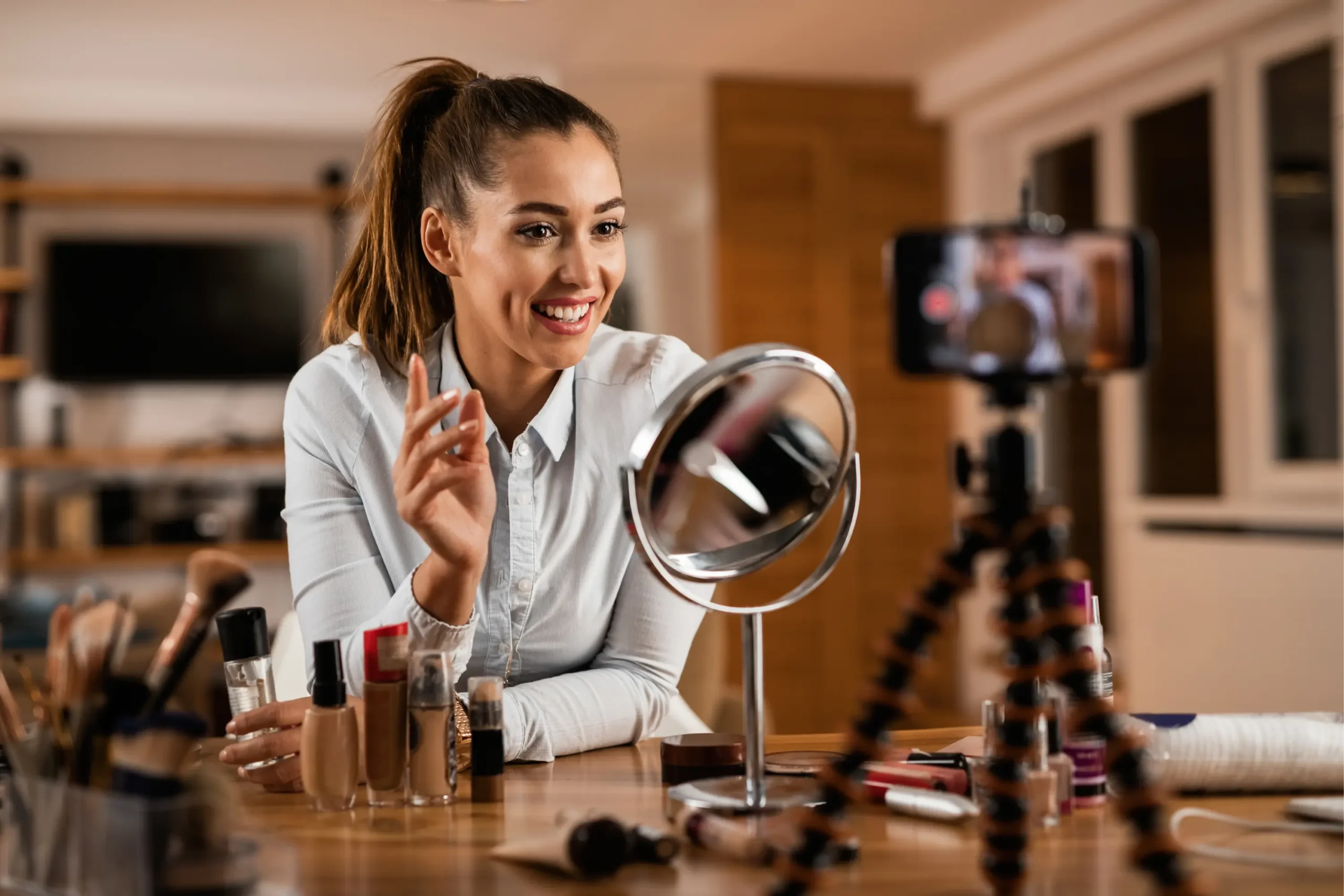 smiling-female-influencer-talking-about-beauty-products-while-vlogging-from-home